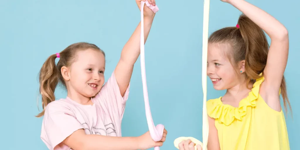 toddlers playing liquid starch slime