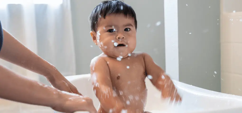 baby bathing on bathtub