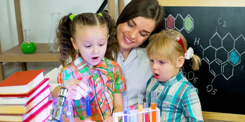 mom shows her daughters some school experiments