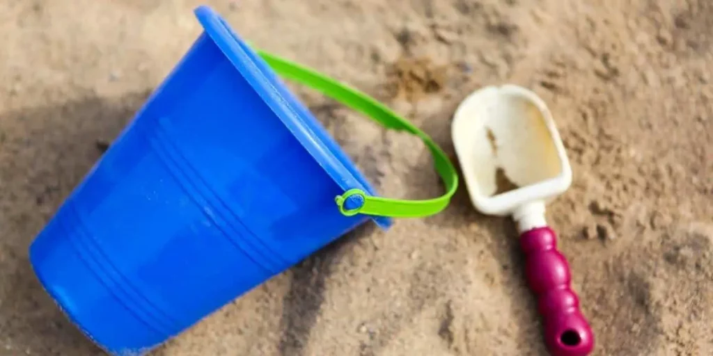 pail and shovel in sand
