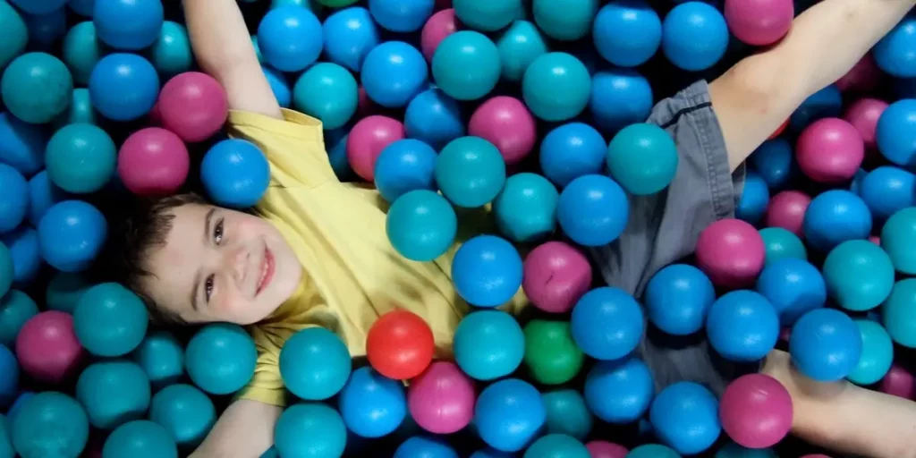 boy playing in ball pit