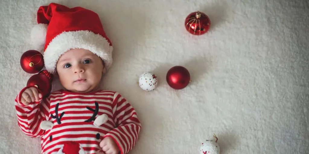 baby in christmas jumpsuit