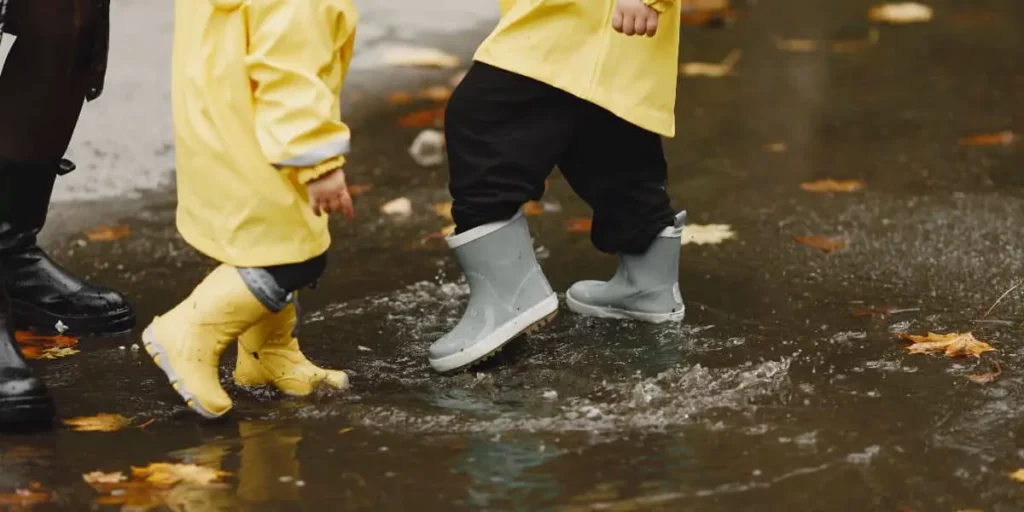 kids playing in rain puddle