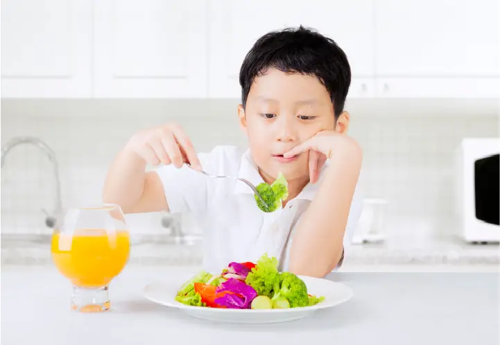 boy eating a salad
