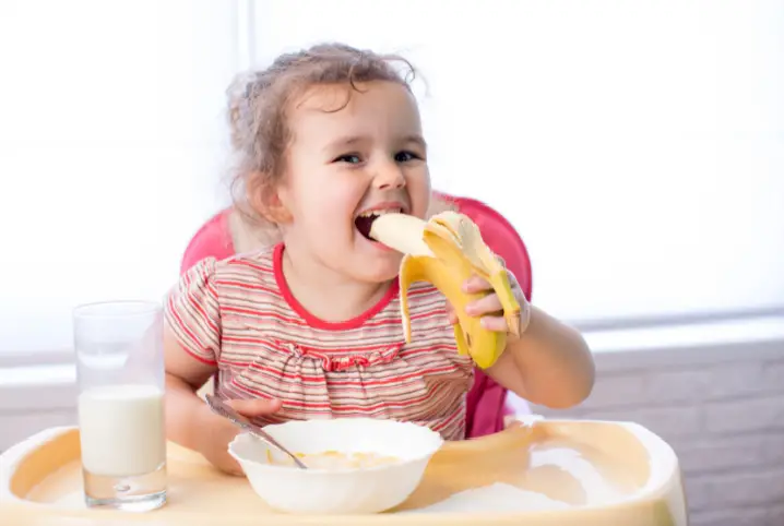 girl eating a banana