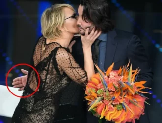 Keanu Reeves kissing an actress on the cheek
