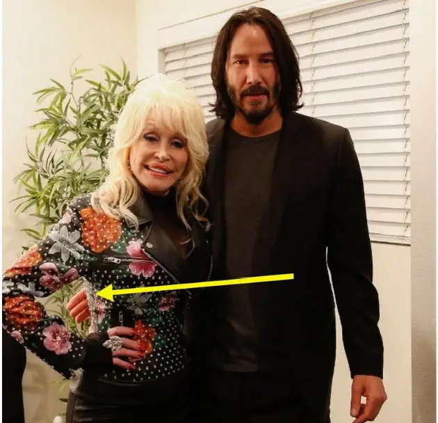 Keanu Reeves posing with Dolly Parton