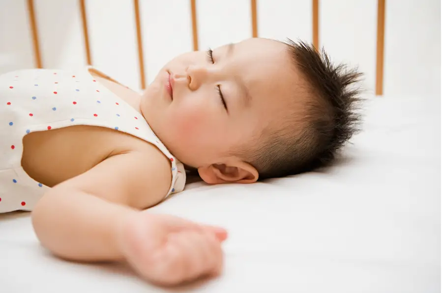 Sleeping little boy in a supine position