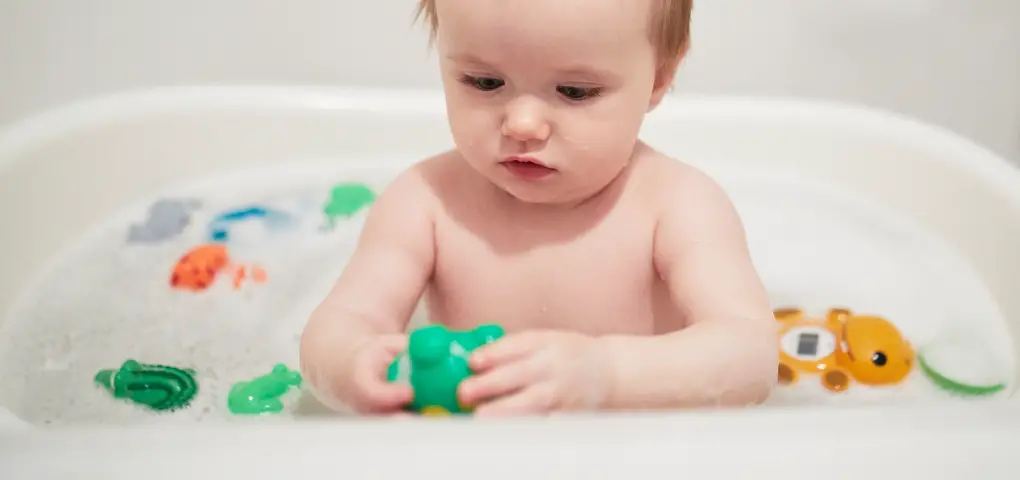 baby in bath playing