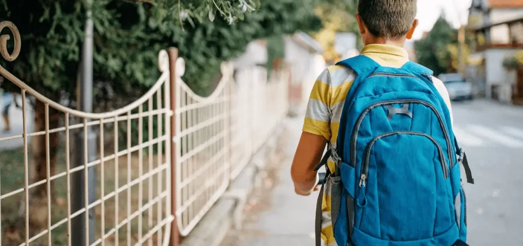a preschooler wearing his school backpack