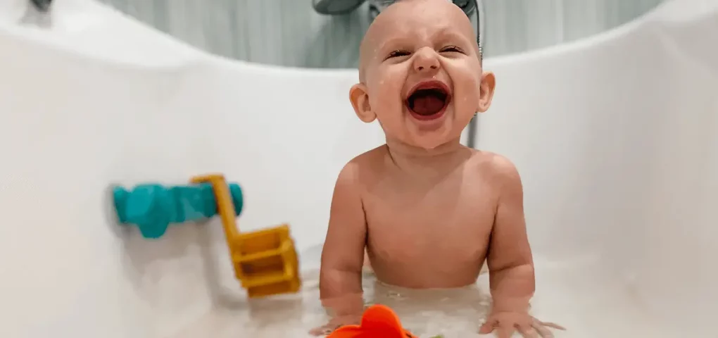 laughing baby on a tub