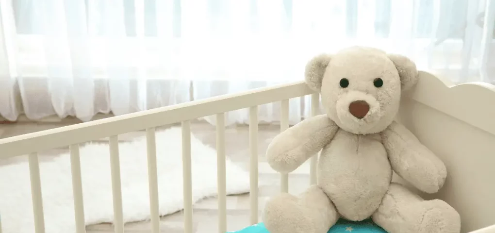 montessori bed with a huge teddy bear