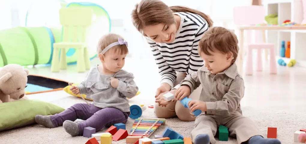 nanny or au pair playing with infants