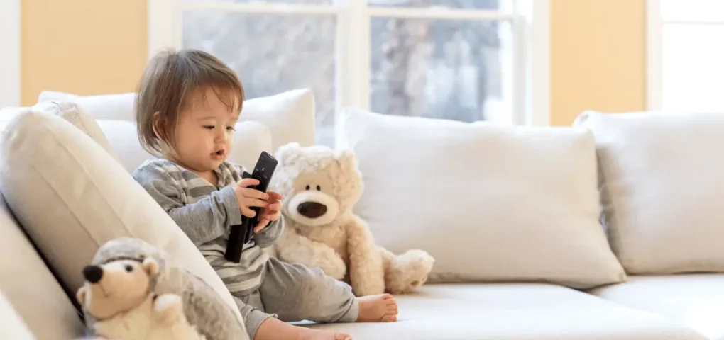 toddler holding a remote control