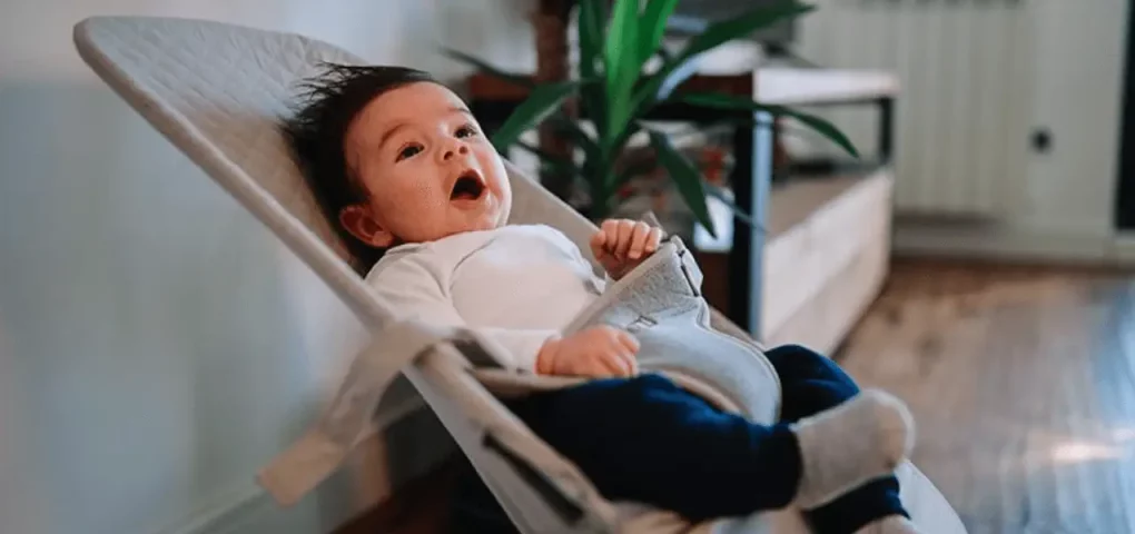 yawning baby on swing